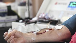 A person donates blood to the American Red Cross during a blood drive January 2022.