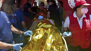 Survivors receive first aid after a rescue operation at the port in Kalamata town, about 240 kilometers southwest of Athens. June 14, 2023