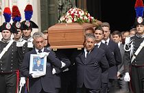 The coffin of media mogul and former Italian Premier Silvio Berlusconi leaves the Milan's Gothic Cathedral at the end his state funeral in northern Italy, Wednesday, June 14,