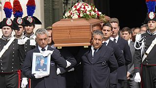 The coffin of media mogul and former Italian Premier Silvio Berlusconi leaves the Milan's Gothic Cathedral at the end his state funeral in northern Italy, Wednesday, June 14, 