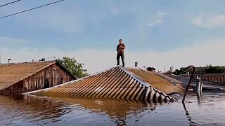 Andriy Levishchenko, 46, volunteer, is playing his saxophone in the flooded Kherson.