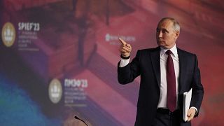 Vladimir Putin leaves a plenary session of the St. Petersburg International Economic Forum.