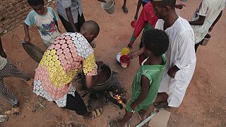 People prepare food in a Khartoum neighbourhood, June 16, 2023.