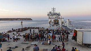  Migrants wait to board an Italian Coast Guard ship in the Sicilian Island of Lampedusa, Italy