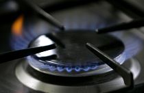 File: A gas-lit flame burns on a natural gas stove.