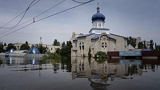 A church is surrounded by water in a flooded neighborhood in Kherson, Ukraine, Thursday, June 8, 2023.