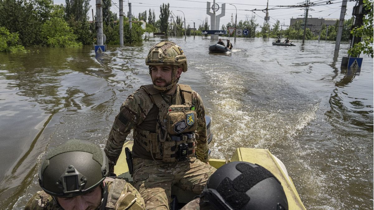 Ukrainian servicemen ride on a speedboat in a flooded neighborhood in Kherson, Ukraine, June 8, 2023.