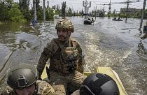 Ukrainian servicemen ride on a speedboat in a flooded neighborhood in Kherson, Ukraine, June 8, 2023.