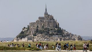 People walk around the Le Mont-Saint-Michel, north-western France, Monday, June 5, 2023. 