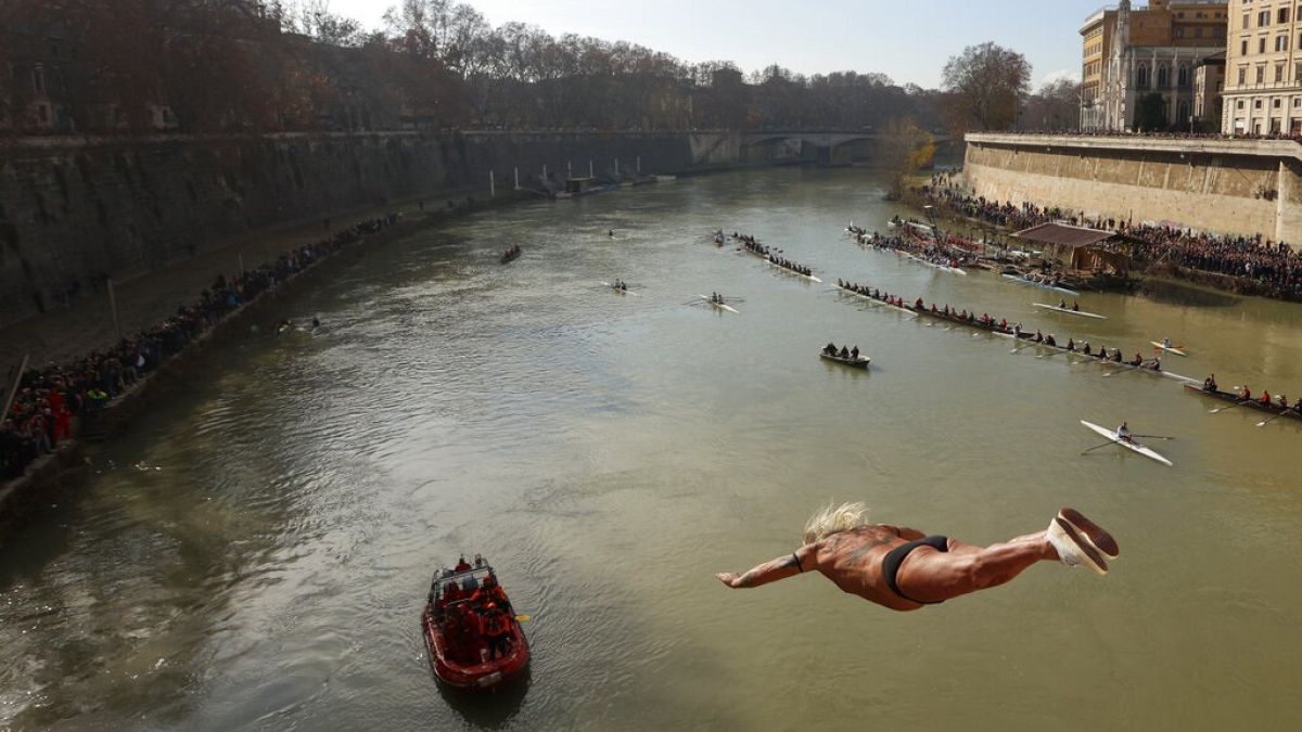 An italian man dives into the Tiber river from the 18 meter (59 feet) high Cavour Bridge.