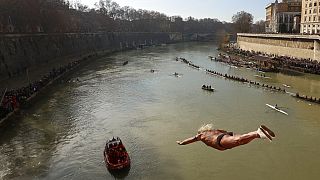 An italian man dives into the Tiber river from the 18 meter (59 feet) high Cavour Bridge.