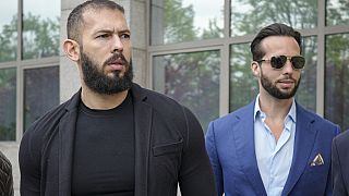 FILE: Andrew Tate, left, and his brother Tristan, right, arrive at the Bucharest Tribunal, in Bucharest, Romania, Friday, April 21, 2023.