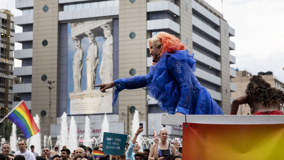A performer points to people participating the annual Pride parade, in Athens, Saturday, 10 June 2023.