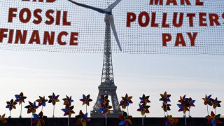 Climate activists protest in Paris demanding end to financing of fossil fuels