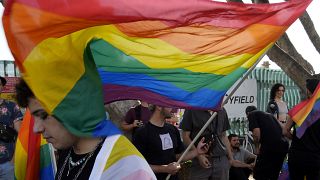 Demonstrators holds rainbow flags during a protest outside from the Parliament house in capital Nicosia, Cyprus, on Thursday, May 25, 2023.