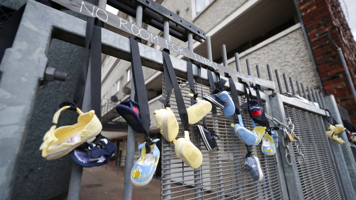Baby shoes hang from railings on Sean McDermott Street in Dublin in memory of the children who died at the Mother and Baby Home in Tuam, Co Galway, 25 August, 2018. 