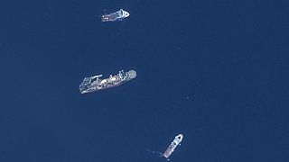 In this satellite image provided by Maxar Technologies, from top to bottom, the vessels Horizon Arctic, Deep Energy and Skandi Vinland search for the missing submersible Titan