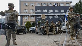 FILE - US soldiers, part of the peacekeeping mission in Kosovo KFOR guard a municipal building in the town of Leposavic, northern Kosovo, on May 29, 2023