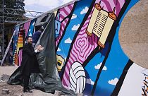 Rabbi Yehuda Teichtal attends the unveiling of a graffiti wall at the entrance of the new Jewish educational and cultural complex.