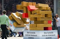 A tower symbolizing the labour market tumbles down after one of the red elements standing for skilled workers was pulled away on May 31, 2011 in Berlin.