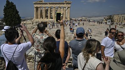 Temple during their visit at the Acropolis archaeological site in Athens