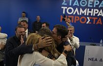 Kyriakos Mitsotakis leader of center-right New Democracy hugs his family at the headquarters of the party in Athens, Greece, Sunday, June 25, 2023.