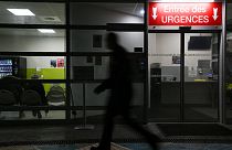 A man passes by an entrance of the emergency department of Emile Muller Hospital in Mulhouse on 16 January 2023.