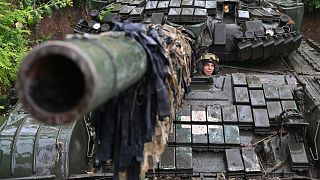 A Ukrainian serviceman sits on a T-72 tank at a position in the Donetsk region on June 25, 2023, amid the Russian invasion of Ukraine.