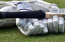 FILE - A close up view of cricket gloves and bat during the second day of the 2nd Test match between England and New Zealand at Edgbaston cricket ground in Birmingham, England