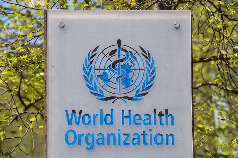 The logo and building of the World Health Organization (WHO) headquarters in Geneva, Switzerland
