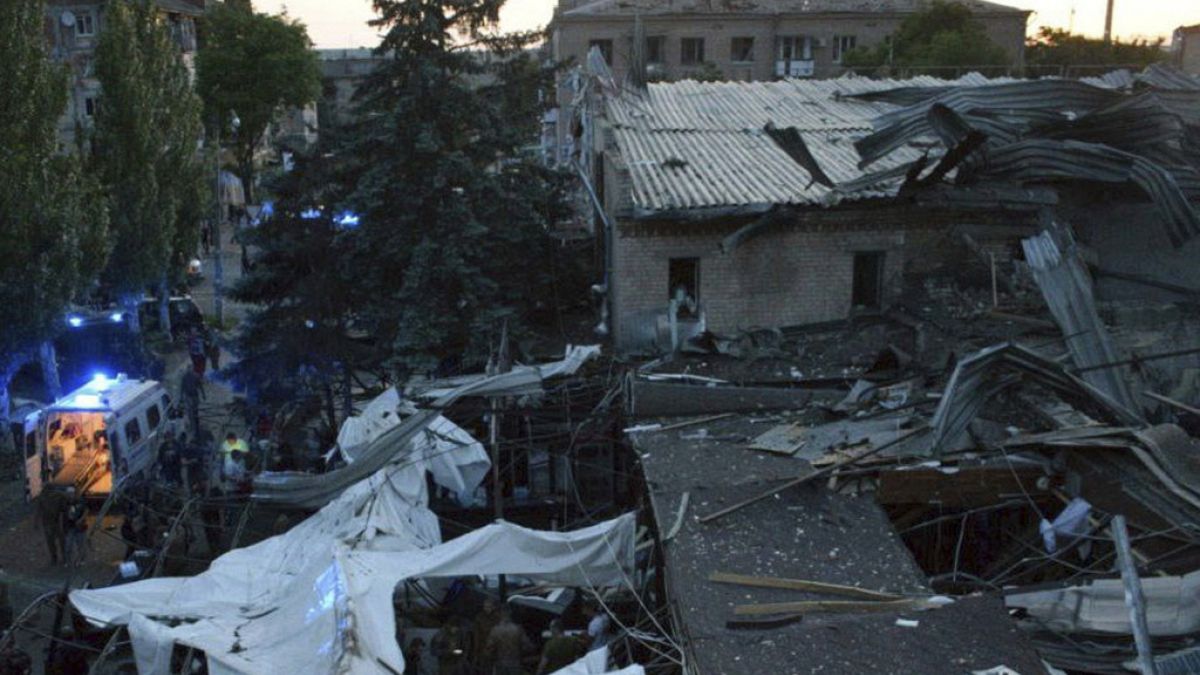 In this photo provided by the National Police of Ukraine, people clear the rubble in a restaurant RIA Pizza destroyed by a Russian attack in Kramatorsk, Ukraine, June 27, 2023