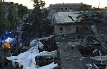 In this photo provided by the National Police of Ukraine, people clear the rubble in a restaurant RIA Pizza destroyed by a Russian attack in Kramatorsk, Ukraine, June 27, 2023