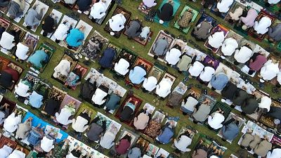 Aerial shot Muslims performing Eid al-Adha prayer on the Blang Padang field.