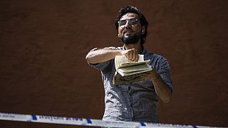 A man destroys a Koran at a protest outside Stockholm's largest mosque