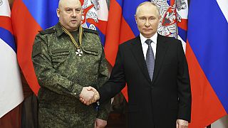 FILE - Russian President Vladimir Putin, right, shakes hands with commander of General Sergei Surovikin, awarded with order of Saint George, Russia, Dec 31, 2022