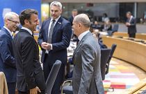 France's President Emmanuel Macron, second left, speaks with Germany's Chancellor Olaf Scholz, right, during a round table meeting at an EU summit in Brussels, June 29, 2023.