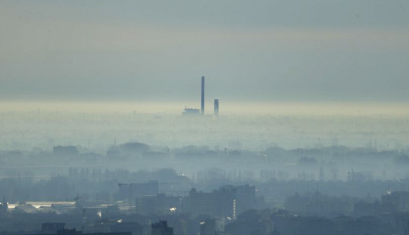 A chimney is seen from an overview of Milan, January 2015