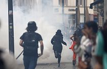 Youths run away during clashes with police forces Friday, June 30, 2023 in Strasbourg, eastern France. French President Macron urged parents Friday to keep teenagers at home.