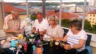 Residents have dinner on the terrace of the Regnbågen retirement community rooftop, in Stockholm.