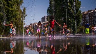 Children cool off at an urban beach at Madrid Rio park in Madrid, Spain, Monday, June 26, 2023