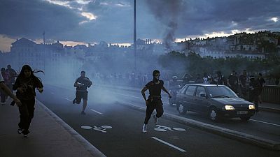People run away during clashes with police in the center of Lyon, central France, Friday, June 30, 2023.