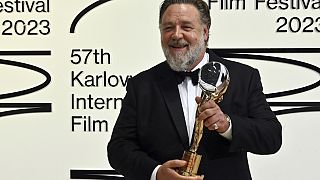 Actor Russell Crowe poses with the Crystal Globe award for contribution to world cinema at the opening ceremony of the 57th Karlovy Vary International Film Festival.