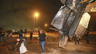 Israeli authorities inspect the remains of what the military said is a Syrian anti-aircraft rocket that exploded in the air, in the town of Rahat, Israel, Sunday, July 2, 2023