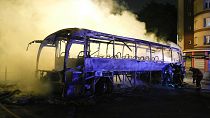 Firefighters use a water hose on a burnt bus in Nanterre, outside Paris, France, July 1, 2023. Firefighters use a water hose on a burnt bus in Nanterre, outside Paris, France, July 1, 2023.