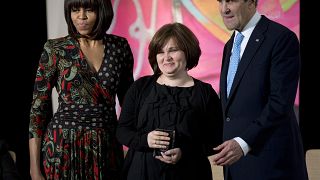 Former First lady Michelle Obama, and former Secretary of State John Kerry with journalist Elena Milashina., March 2013