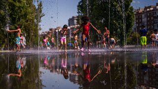 Children cool off at an urban beach at Madrid Rio park in Madrid, Spain, 26 June 2023.