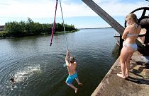 Youths jump into the sea on a hot summer's day, in Vaasa, Finland, July 19, 2018.