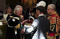 Britain's King Charles III is presented with the Crown of Scotland during the National Service of Thanksgiving and Dedication for King Charles III and Queen Camilla