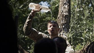 A Ukrainian soldier cools himself with water on the frontline near Bakhmut, Donetsk region, Ukraine, Tuesday, July 4 2023.