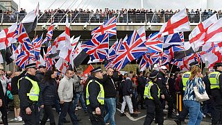 Britain First and English Defence League protesters wave British flags as they march through central London, Saturday April 1, 2017.